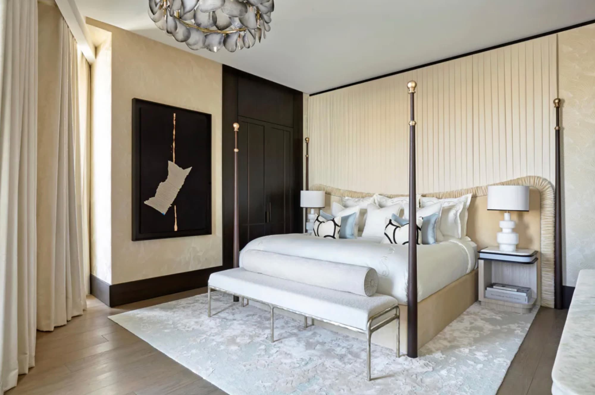 Principal bedroom with four-poster bed and panelled headboard wall, comfort with no visible air conditioning units