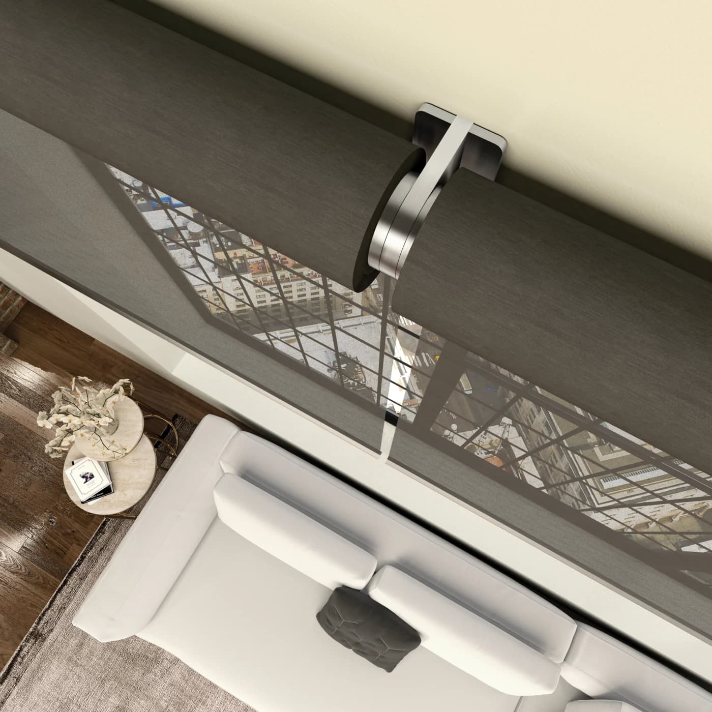 A motorised roller blind part-lowered across a floor-to-ceiling window, its quiet motor and bracket visible at the head, with a city view beyond