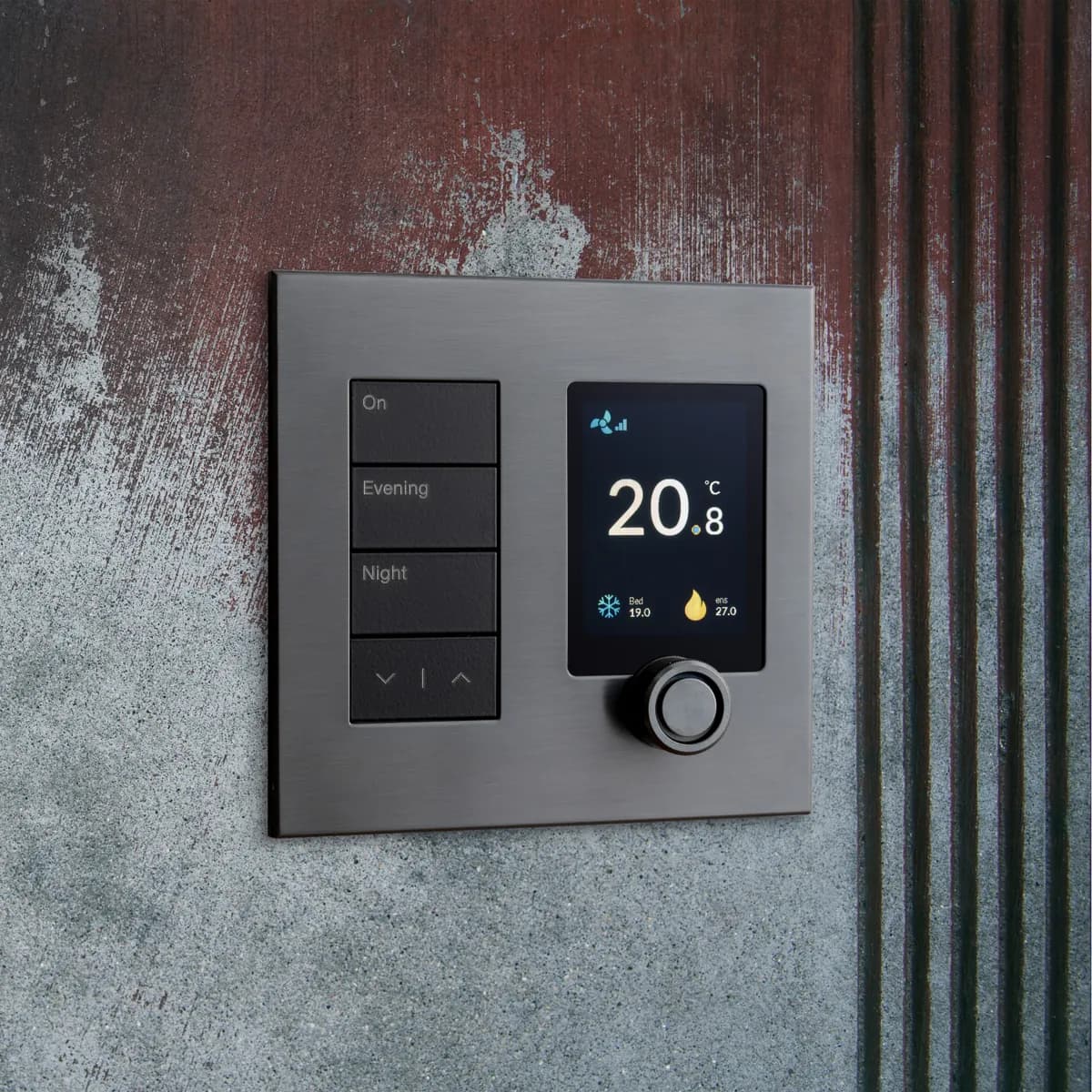 A brushed stainless Crestron climate panel set into a wall, showing 20.8°C with On, Evening and Night buttons and a control dial