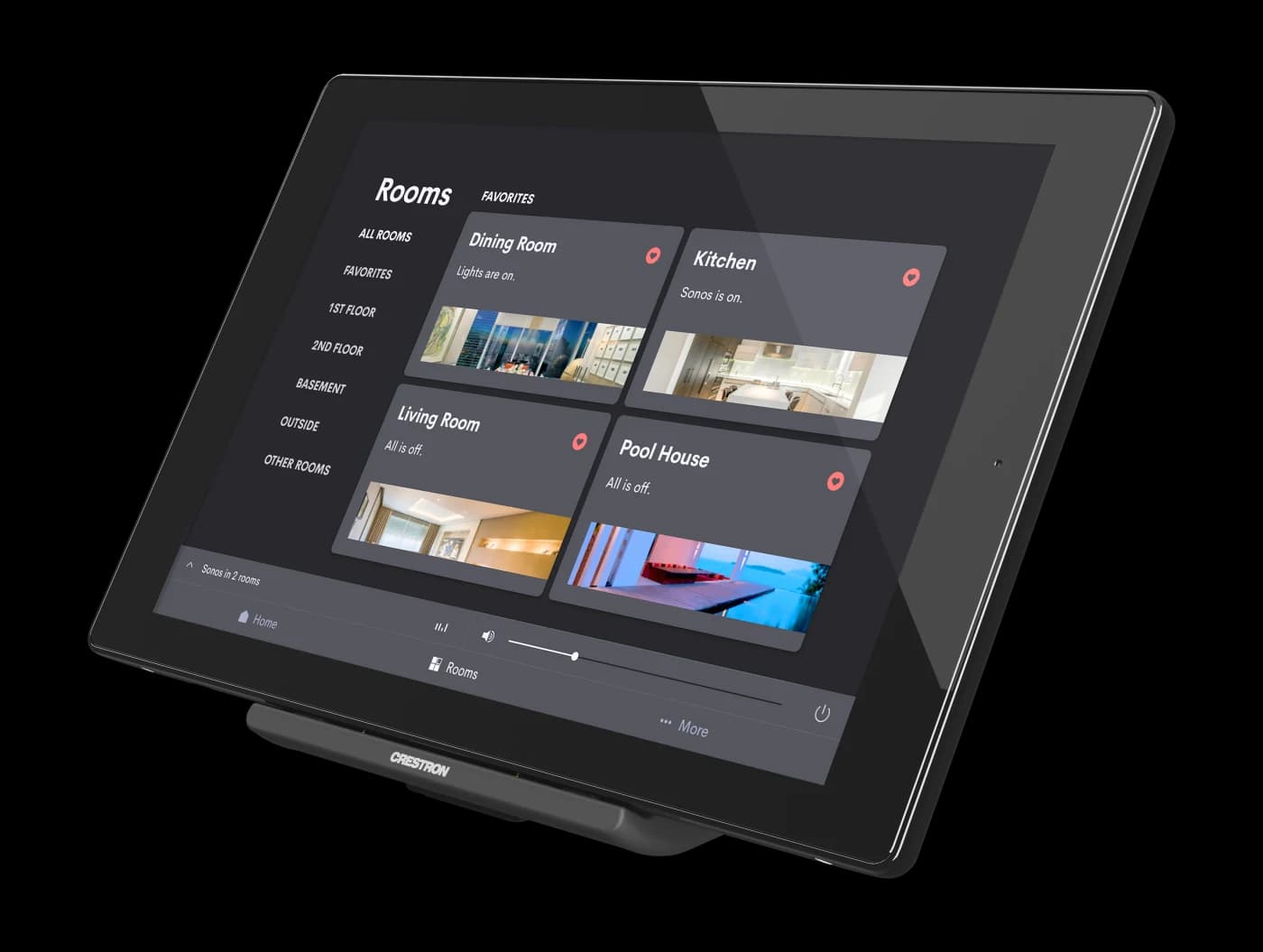 A Crestron tablet on a desk stand showing the Rooms view, each room reporting whether its lights and music are on